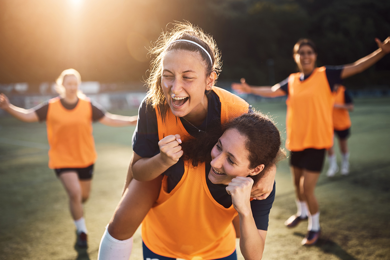 Image of girls celebrating on a sporting field